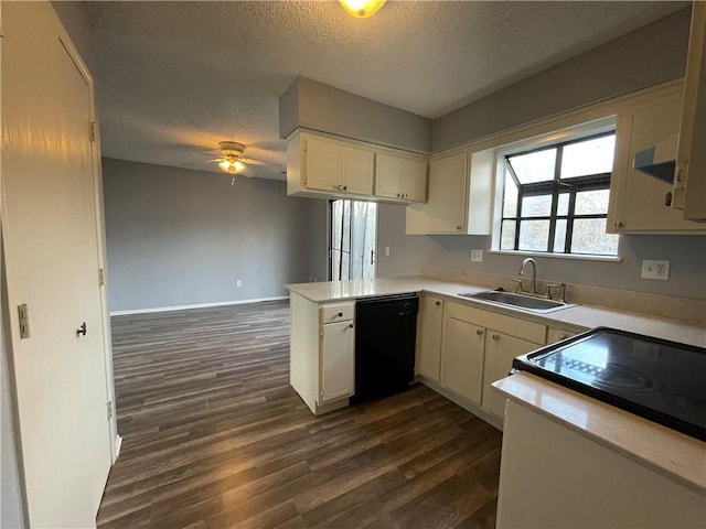 kitchen with a ceiling fan, dark wood-style flooring, a textured ceiling, a sink, and black appliances