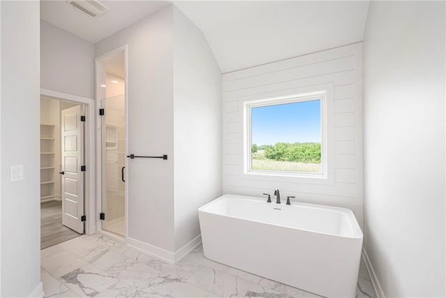 10075 NW Hillsboro Rd, Platte City, MO 64079 - full bathroom with marble look tile flooring, a freestanding bath, a walk in closet, and a stall shower