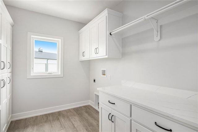 10075 NW Hillsboro Rd, Platte City, MO 64079 - laundry room with washer hookup, light wood-style floors, hookup for an electric dryer, and cabinet space