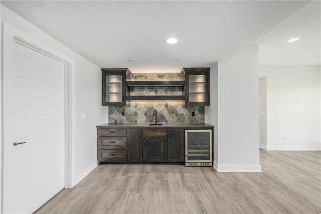 10075 NW Hillsboro Rd, Platte City, MO 64079 - indoor wet bar with beverage cooler, light wood finished floors, backsplash, and recessed lighting