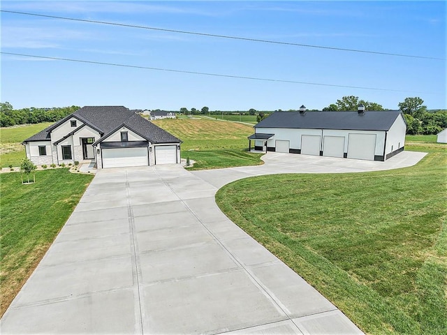 10075 NW Hillsboro Rd, Platte City, MO 64079 - view of grassy yard featuring driveway and a garage