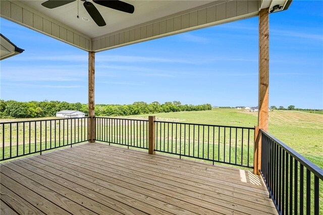 10075 NW Hillsboro Rd, Platte City, MO 64079 - wooden terrace featuring ceiling fan, a lawn, and a rural view