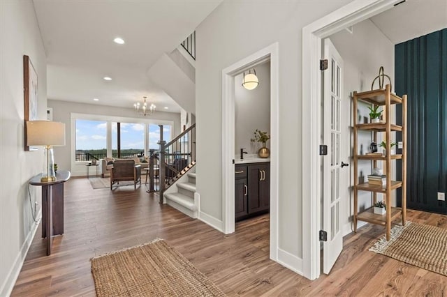 17163 S Laurelwood St, Olathe, KS 66062 - foyer featuring baseboards, light wood-style flooring, recessed lighting, a chandelier, and stairway