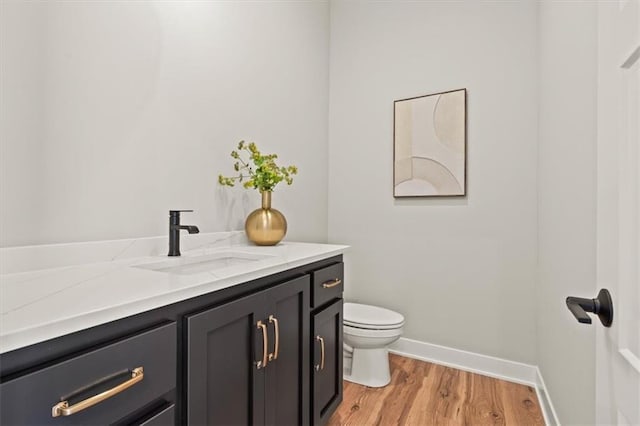 17163 S Laurelwood St, Olathe, KS 66062 - half bathroom with toilet, vanity, wood finished floors, and baseboards