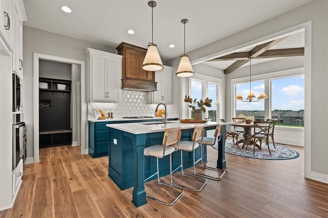 17163 S Laurelwood St, Olathe, KS 66062 - kitchen with a sink, beamed ceiling, recessed lighting, light countertops, and tasteful backsplash