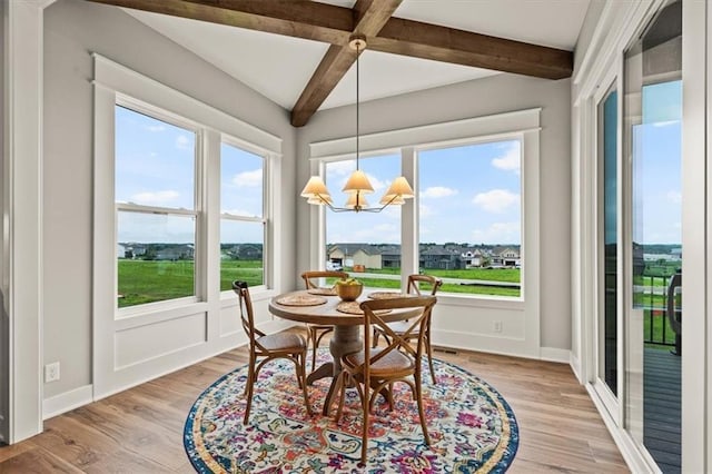 17163 S Laurelwood St, Olathe, KS 66062 - dining space with beam ceiling, plenty of natural light, light wood-type flooring, and baseboards