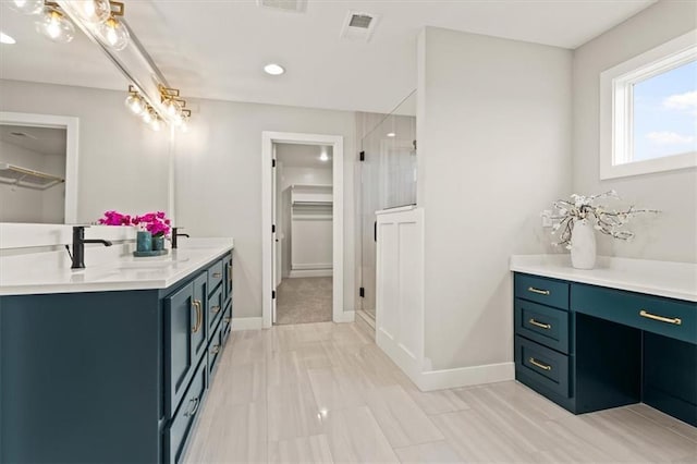 17163 S Laurelwood St, Olathe, KS 66062 - bathroom with double vanity, a walk in closet, a shower stall, recessed lighting, and baseboards