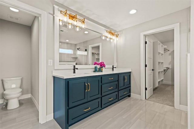 17163 S Laurelwood St, Olathe, KS 66062 - full bath featuring a spacious closet, double vanity, toilet, baseboards, and recessed lighting