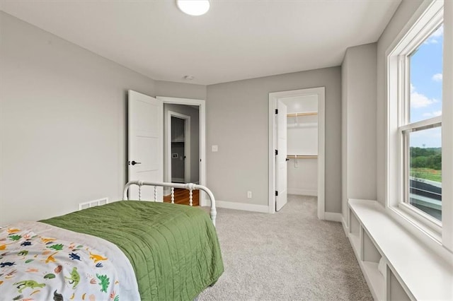17163 S Laurelwood St, Olathe, KS 66062 - bedroom with light colored carpet, baseboards, a walk in closet, and a closet