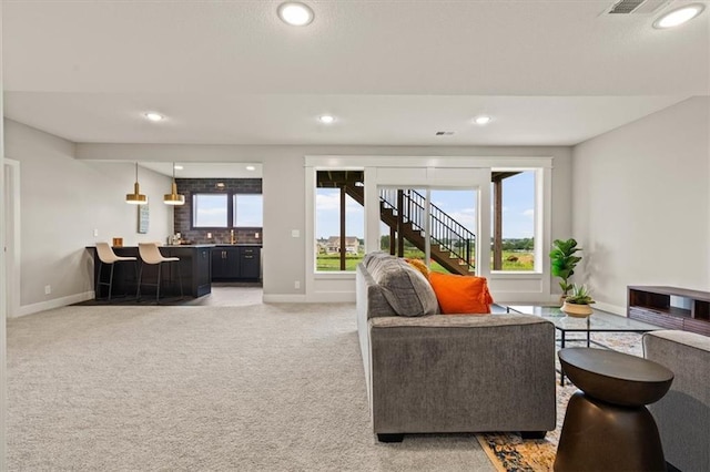17163 S Laurelwood St, Olathe, KS 66062 - living room with baseboards, bar area, recessed lighting, light colored carpet, and stairway