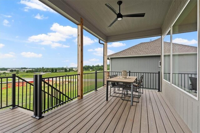 17163 S Laurelwood St, Olathe, KS 66062 - wooden terrace featuring a ceiling fan, outdoor dining space, and a lawn
