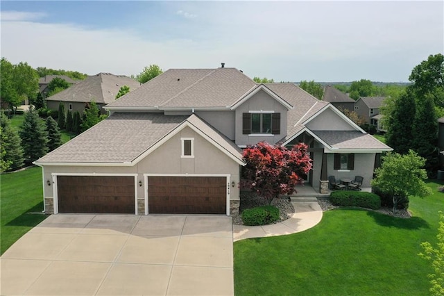 craftsman-style house featuring an attached garage, driveway, stone siding, and a front lawn