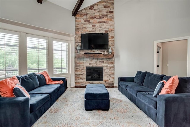 living room featuring a stone fireplace, high vaulted ceiling, and beamed ceiling