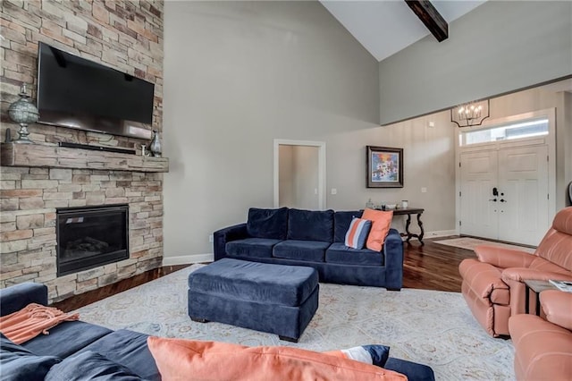 living room with an inviting chandelier, high vaulted ceiling, baseboards, and wood finished floors
