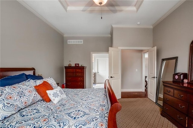 carpeted bedroom featuring visible vents, ornamental molding, baseboards, and ceiling fan
