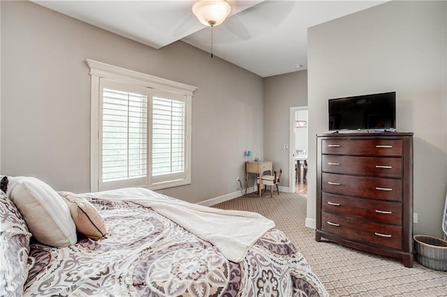 bedroom with baseboards, ceiling fan, and light carpet