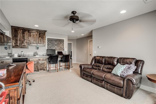 living room featuring baseboards, a ceiling fan, recessed lighting, and light colored carpet