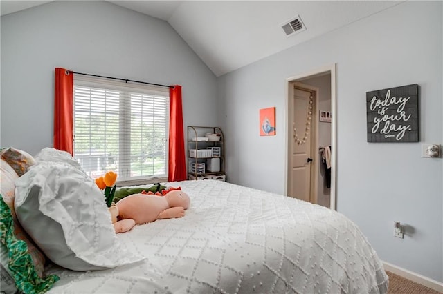 bedroom featuring visible vents, baseboards, carpet floors, and lofted ceiling