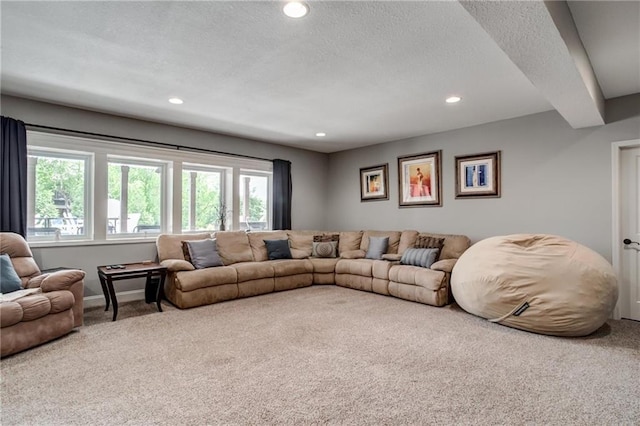 living room with recessed lighting, a textured ceiling, carpet, and baseboards