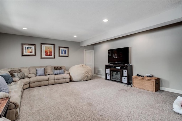 carpeted living area featuring recessed lighting, baseboards, and visible vents