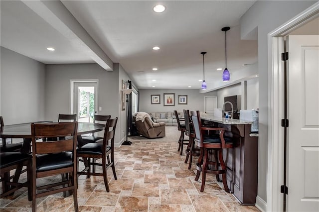 dining area featuring recessed lighting, stone tile floors, and baseboards