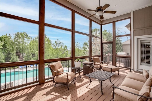 sunroom with an outdoor living space and a ceiling fan