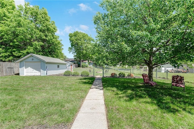 view of yard featuring a garage and an outbuilding