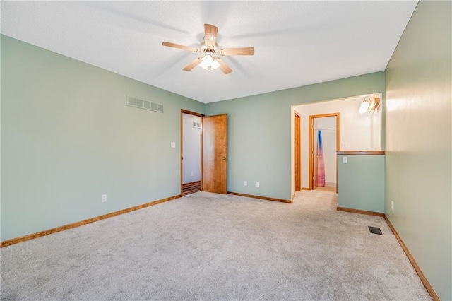unfurnished bedroom with carpet flooring, baseboards, and ceiling fan