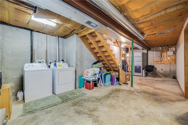 unfinished basement featuring independent washer and dryer and stairs