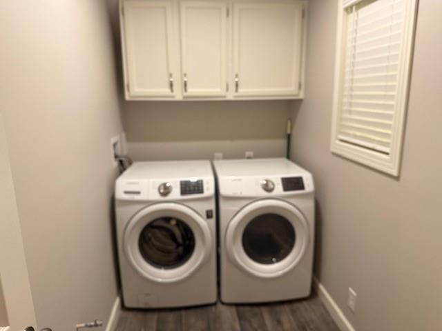 laundry room with washing machine and dryer, cabinet space, dark wood-style flooring, and baseboards