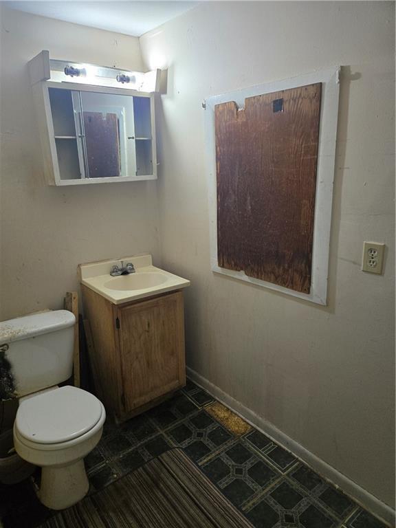 bathroom with tile patterned floors, vanity, and toilet