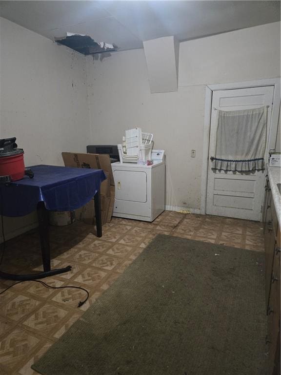 washroom with light floors, washer / clothes dryer, and laundry area