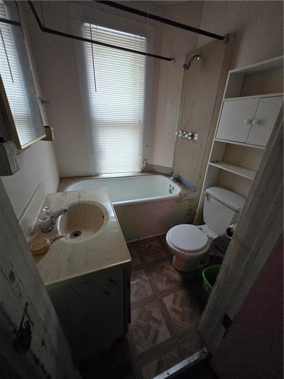 full bath with toilet, shower / washtub combination, and vanity