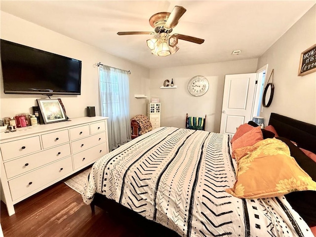 bedroom featuring visible vents, ceiling fan, and wood finished floors