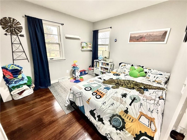 bedroom with baseboards and wood finished floors