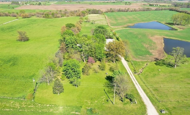 birds eye view of property featuring a water view and a rural view