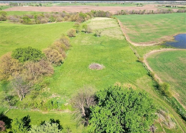 birds eye view of property with a water view and a rural view
