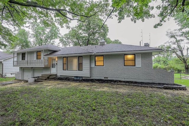 tri-level home with a front lawn, a garage, and a chimney