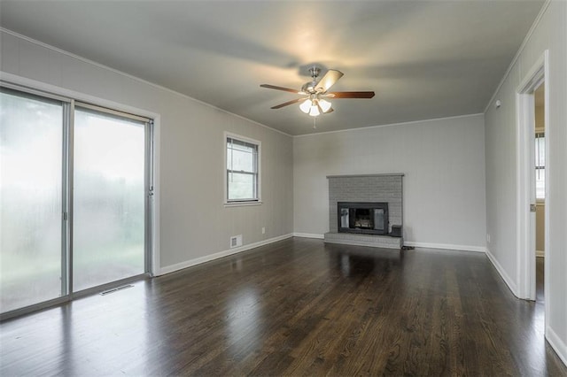 unfurnished living room with baseboards, dark wood-style floors, visible vents, a ceiling fan, and crown molding
