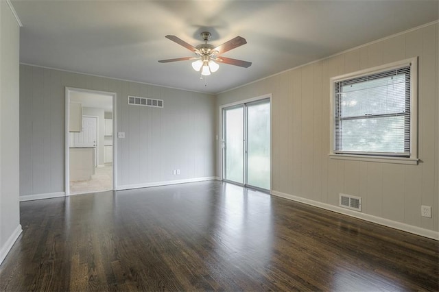interior space with wood finished floors, visible vents, and baseboards