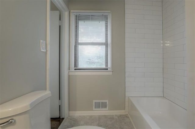bathroom featuring toilet, visible vents, bathtub / shower combination, and baseboards