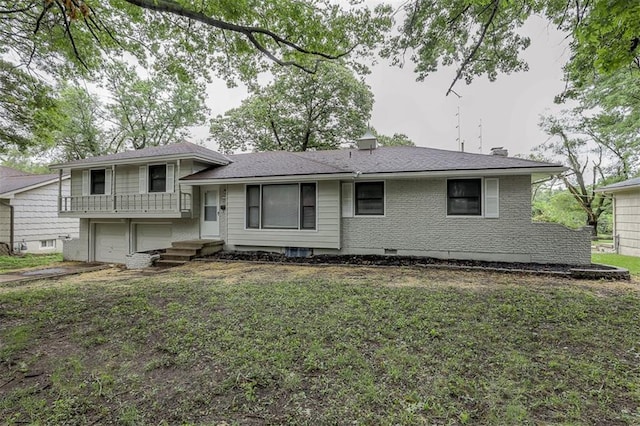 rear view of house with driveway and an attached garage