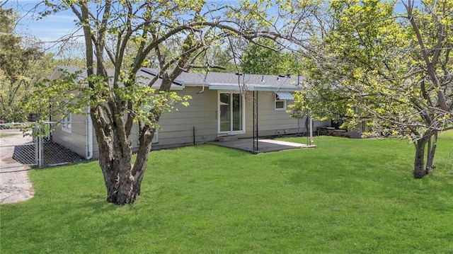 back of property featuring a lawn and concrete driveway