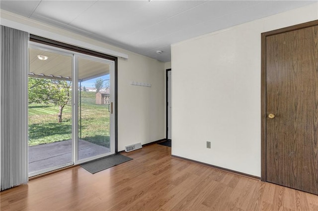 spare room featuring visible vents and light wood-style floors