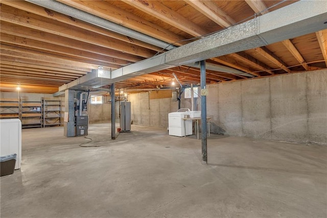 basement featuring heating unit, washer / clothes dryer, and water heater