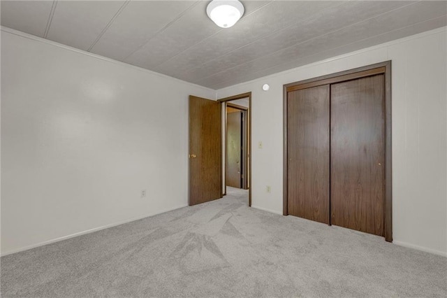 unfurnished bedroom with carpet floors and a closet