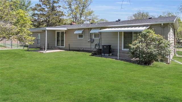 back of house featuring fence, a yard, a patio, and cooling unit