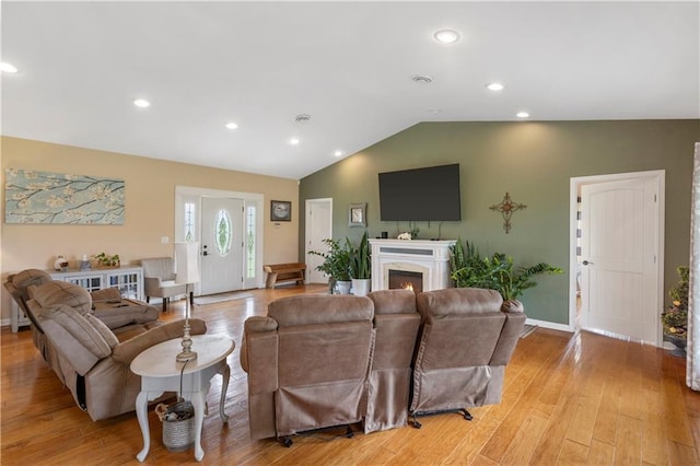living room with baseboards, recessed lighting, light wood finished floors, and lofted ceiling