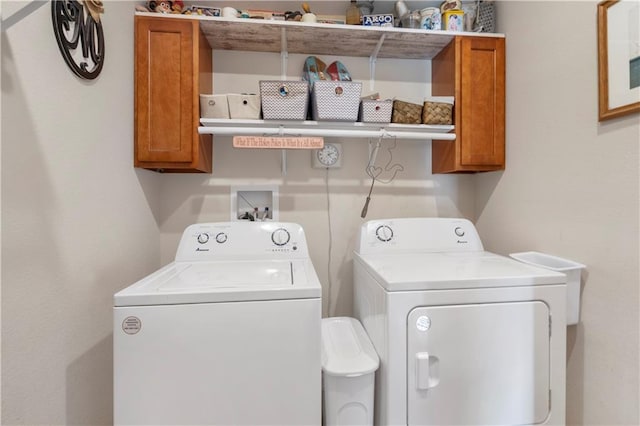 laundry area with cabinet space and washing machine and clothes dryer