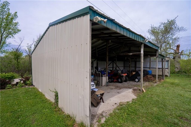 view of pole building with a detached carport and a yard